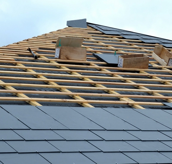 Toiture ardoise grise sur toit charpente bois, offrant une finition élégante et durable, parfaitement installée sur une structure en bois robuste